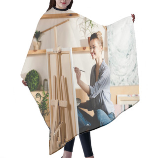 Personality  Smiling Female Artist Sitting On Table And Drawing On Canvas In Studio Hair Cutting Cape