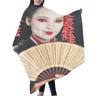 Personality  Portrait Of Smiling Beautiful Geisha In Black And Red Kimono And Flowers In Hair Holding Hand Fan Isolated On Black Hair Cutting Cape