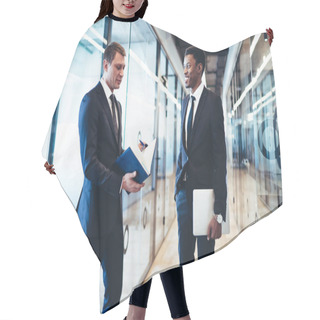 Personality  Smiling Adult Ethnic Employee In Elegant Suit Listening Pensive Colleague While Standing And Having Conversation In Modern Office Corridor Against Glass Walls Hair Cutting Cape
