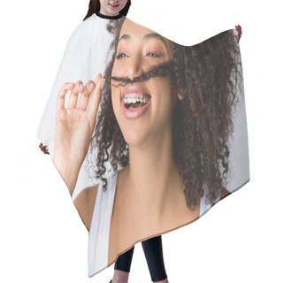 Personality  Laughing African American Girl With Dental Braces Making Fake Mustache From Hair, Isolated On Grey Hair Cutting Cape