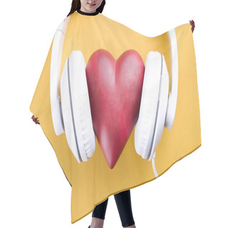 Personality  Listen To Your Heart Concept. Big Red Heart With White Headphones Over Bright Yellow Background. St. Valentine Day Composition Headset And Heart. Close Up, Copy Space, Top View, Flat Lay, Hair Cutting Cape