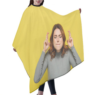 Personality  Worried Woman With Closed Eyes Holding Crossed Fingers While Standing On Yellow Hair Cutting Cape