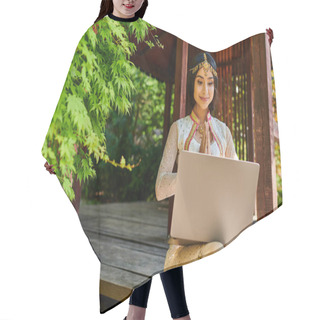 Personality  Smiling Indian Woman In Traditional Clothes Showing Greeting Gesture During Video Call On Laptop Hair Cutting Cape