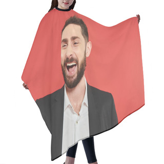 Personality  Portrait Of Excited Bearded Businessman In Black Suit Looking Away And Laughing On Red Backdrop Hair Cutting Cape