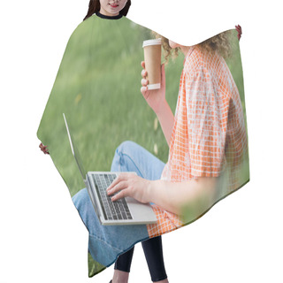 Personality  Cropped View Of Cheerful Freelancer With Curly Hair Holding Paper Cup And Using Laptop While Sitting On Grass  Hair Cutting Cape