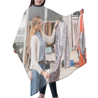 Personality  Stylish Woman Looking At Dress On Hanger In Showroom  Hair Cutting Cape