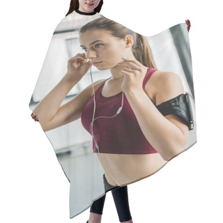Personality  Concentrated Sportswoman In Smartphone Armband Putting On Earphones At Gym Hair Cutting Cape