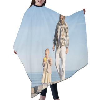 Personality  Young Man Walking Near Baby Daughter With Apple On Pier On Beach In Italy  Hair Cutting Cape