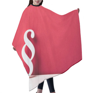 Personality  Close-up Of A Paragraph Symbol Leaning On Red Wall Hair Cutting Cape