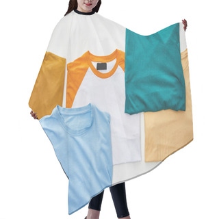 Personality  Top View Of Beige, Orange, Blue, Turquoise And Ochre Folded T-shirts On White Background Hair Cutting Cape