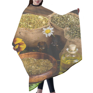 Personality  Sackcloth Bags With Dried Herbs, Bottles With Essential Oils And Chamomile Flowers On Wooden Surface Hair Cutting Cape