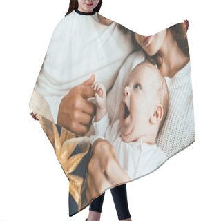 Personality  Cropped View Of Parents Holding Adorable Little Baby Near Gift Box With Golden Ribbon Hair Cutting Cape