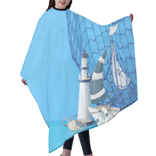 Personality  Nautical Concept With White Decorative Sail Boat, Lighthouse, Seashells And Fishnet Over Blue Wooden Table And Background. Hair Cutting Cape