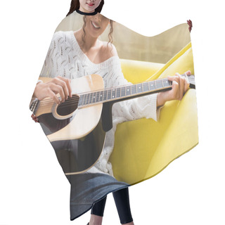 Personality  Cropped View Of Young Curly Woman Playing Acoustic Guitar On Sofa In Living Room  Hair Cutting Cape