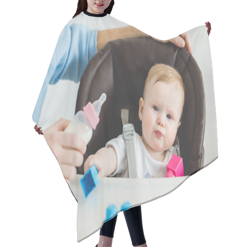 Personality  Cropped View Of Father Holding Feeding Bottle And Infant Daughter Sitting In Baby Chair With Plastic Blocks Hair Cutting Cape
