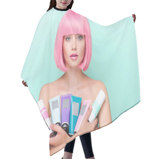 Personality  Young Woman With Pink Bob Cut Holding Various Tubes Of Coloring Hair Tonics Looking At Camera Isolated On Turquoise Hair Cutting Cape