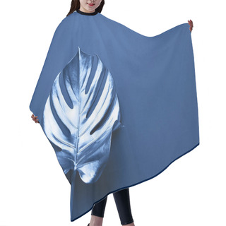 Personality  Exotic Summer Trend In Minimal Style. Tropical Palm Monstera Leaf On Classic Blue Color Background. Shiny And Sparkle Design, Fashion Concept. Hair Cutting Cape
