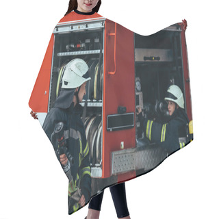 Personality  Male Firefighter In Uniform Holding Water Hose While Colleague Checking Equipment In Truck On Street Hair Cutting Cape