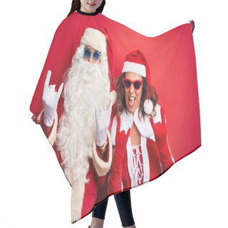 Personality  Middle Age Couple Wearing Santa Costume And Sunglasses Over Isolated Red Background Shouting With Crazy Expression Doing Rock Symbol With Hands Up. Music Star. Heavy Concept. Hair Cutting Cape