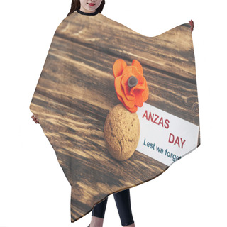 Personality  Card With Anzas Day Lettering Near Artificial Flower And Cookie On Wooden Surface  Hair Cutting Cape