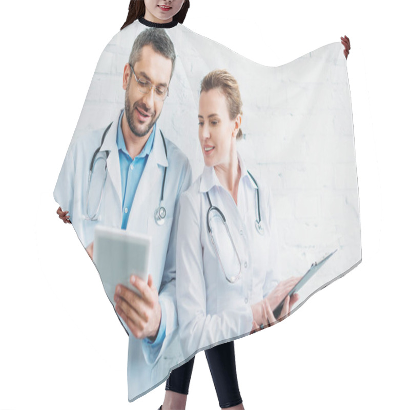 Personality  happy doctors working together with tablet and clipboard hair cutting cape