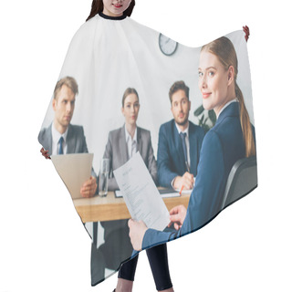 Personality  Selective Focus Of Employee Looking At Camera While Holding Resume Near Recruiters Hair Cutting Cape