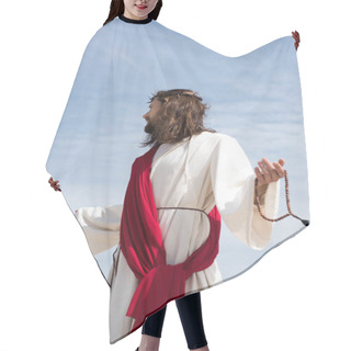 Personality  Jesus In Robe, Red Sash And Crown Of Thorns Holding Rosary And Standing With Open Arms Against Blue Sky, Looking Away Hair Cutting Cape