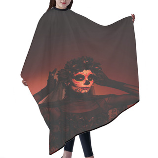 Personality  Woman In Santa Muerte Traditional Costume Adjusting Wreath On Burgundy Background With Red Lighting  Hair Cutting Cape