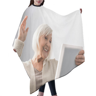 Personality  Cheerful Senior Woman Sitting With Raised Hand While Using Digital Tablet Hair Cutting Cape