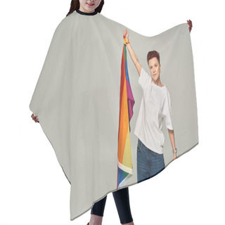 Personality  Serious Redhead Bigender Person In White T-shirt And Jeans Standing With LGBT Flag On Grey Backdrop Hair Cutting Cape