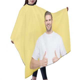 Personality  Pleased Man Smiling At Camera And Showing Thumbs Up On Yellow Hair Cutting Cape