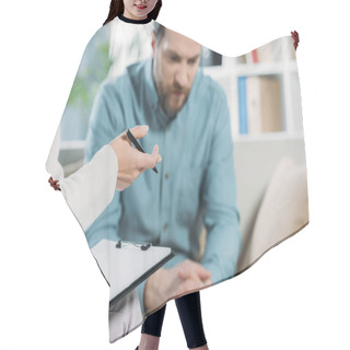 Personality  Cropped Shot Of Psychotherapist Holding Pen And Clipboard While Upset Bearded Man Sitting On Couch Hair Cutting Cape