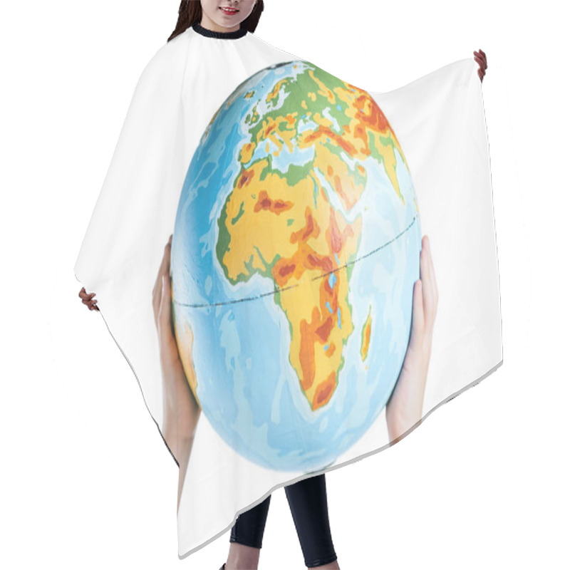 Personality  partial view of child holding globe in raised hands isolated on white, earth day concept hair cutting cape