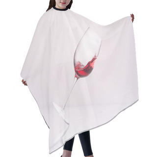 Personality  Inclined Glass With Splashing Red Wine On Reflective Surface And On White Hair Cutting Cape