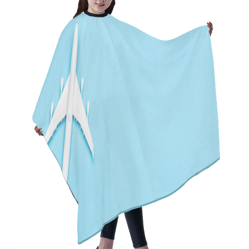Personality  top view of white plane model on blue background, banner hair cutting cape