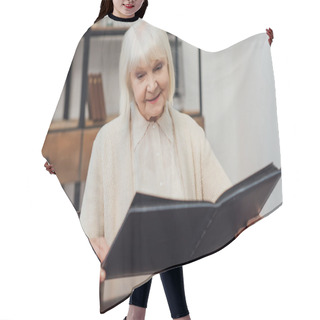 Personality  Smiling Senior Woman With Grey Hair Sitting At Table And Looking At Photo Album At Home Hair Cutting Cape