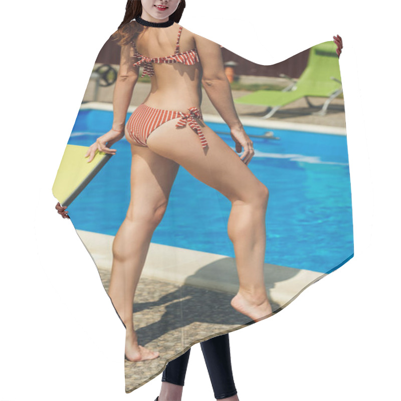 Personality  cropped shot of slim woman in bikini at poolside hair cutting cape