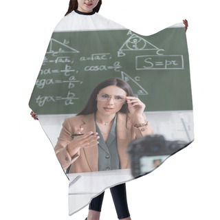 Personality  Teacher In Eyeglasses Talking Near Blurred Digital Camera And Chalkboard  Hair Cutting Cape