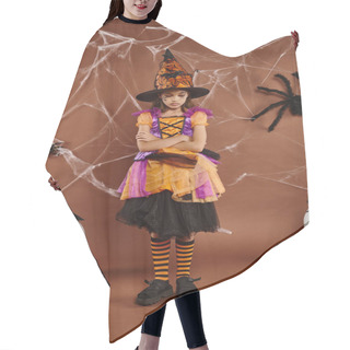 Personality  Sad Girl In Witch Hat And Halloween Costume Standing With Folded Arms On Brown Backdrop, Cobwebs Hair Cutting Cape