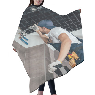 Personality  Low Angle View Of Plumber Standing On Ladder And Working With Pipes In Bathroom  Hair Cutting Cape