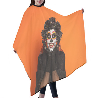 Personality  Smiling Woman In Sugar Skull Makeup And Black Halloween Costume Holding Hands Near Face Isolated On Orange Hair Cutting Cape