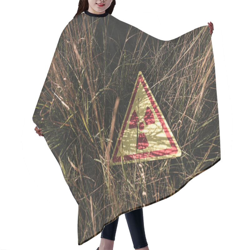 Personality  top view of triangle with warning toxic symbol on grass, post apocalyptic concept hair cutting cape