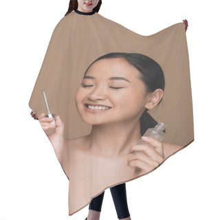 Personality  Positive Asian Woman With Naked Shoulders Holding Serum Isolated On Brown  Hair Cutting Cape