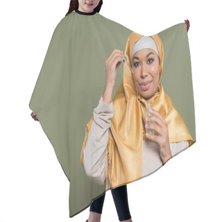 Personality  Young Multiracial Woman In Hijab Holding Serum And Dropper On Green Background Hair Cutting Cape