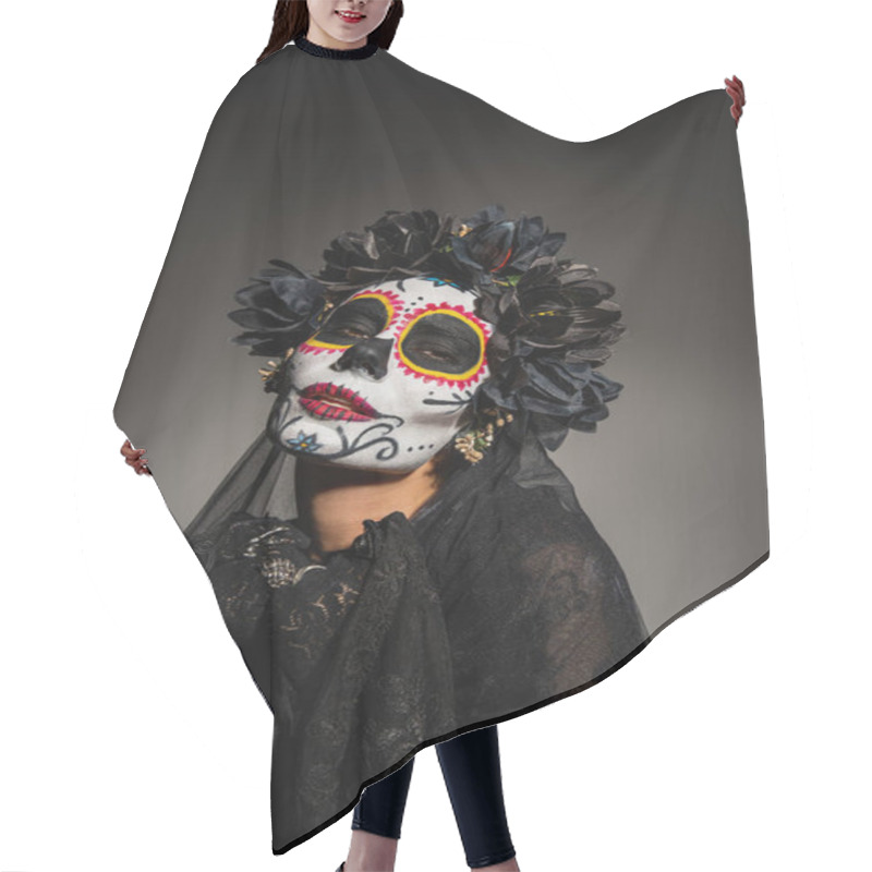 Personality  Portrait of woman in mexican day of dead costume looking at camera on black background  hair cutting cape