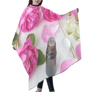 Personality  A Bottle Of Essential Oil With Fresh Roses On A White Table Hair Cutting Cape
