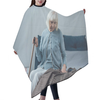 Personality  Sad Senior Woman Sitting On Bed, Holding Walking Stick And Looking At Jacket At Home Hair Cutting Cape
