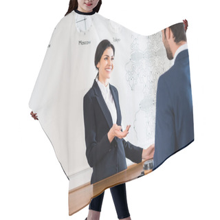 Personality  Selective Focus Of Happy Receptionist Gesturing While Looking At Man  Hair Cutting Cape