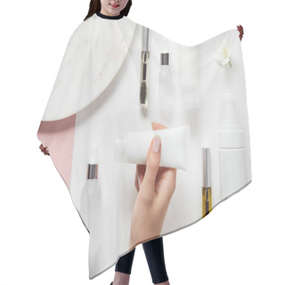 Personality  Cropped View Of Woman Holding Cream Tube In Hands Over Mascara And Glass Bottles, Cosmetic Dispenser, Plate, Jasmine On White Pink Surface Hair Cutting Cape