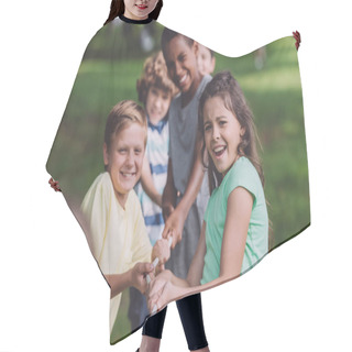Personality  Selective Focus Of Cheerful Multicultural Kids Competing In Tug Of War  Hair Cutting Cape